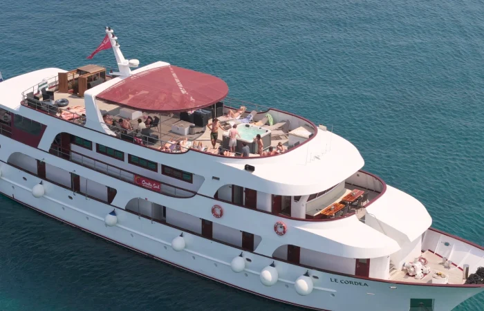 An areal shot of Go Croatia Sail Superior boat, Le Cordea, with people sunbathing on the top deck on a sunny day