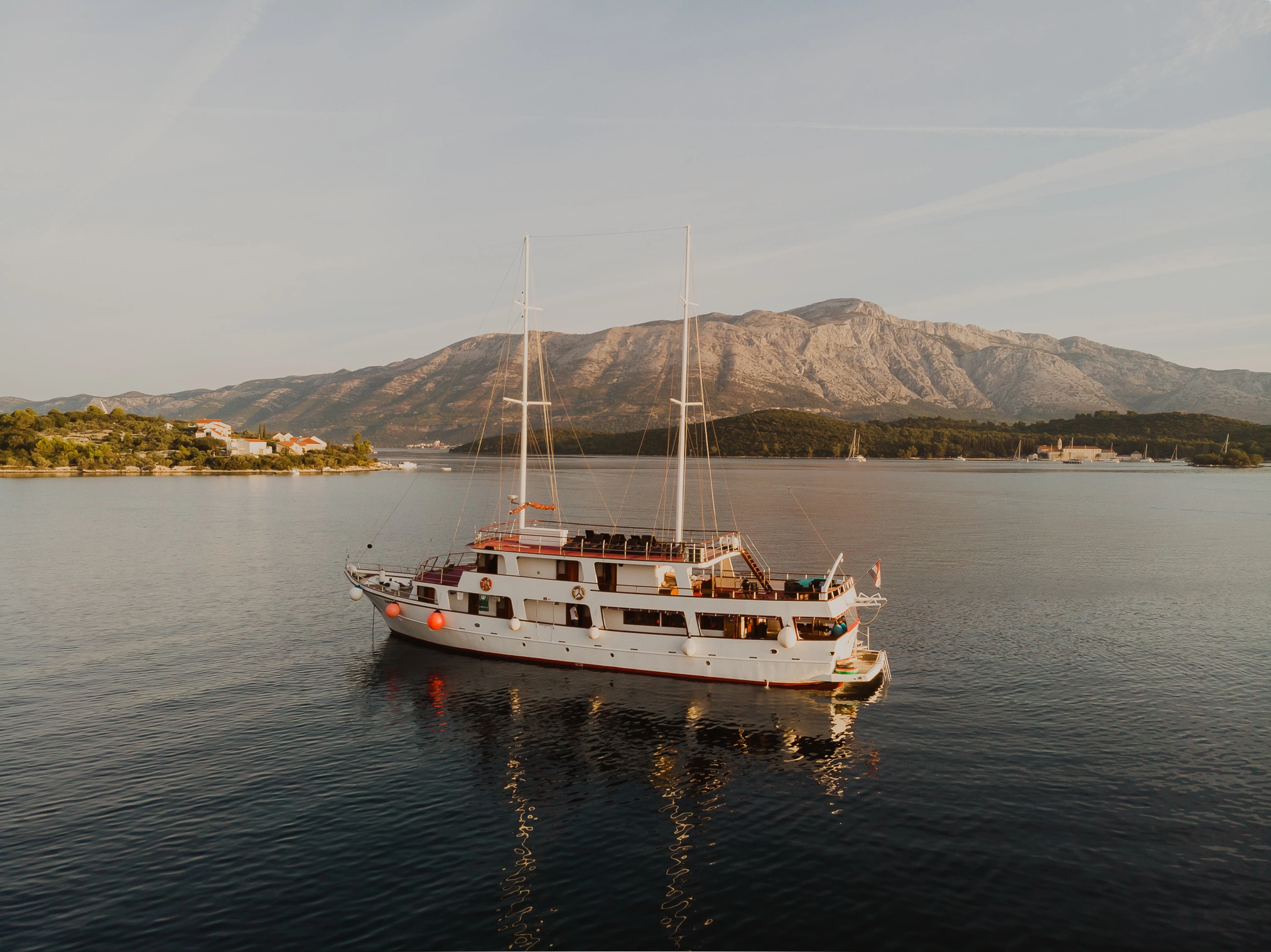 A photo of Go Croatia Sail Premier boat, Vapor, docked at a bay during dusk on a summer day